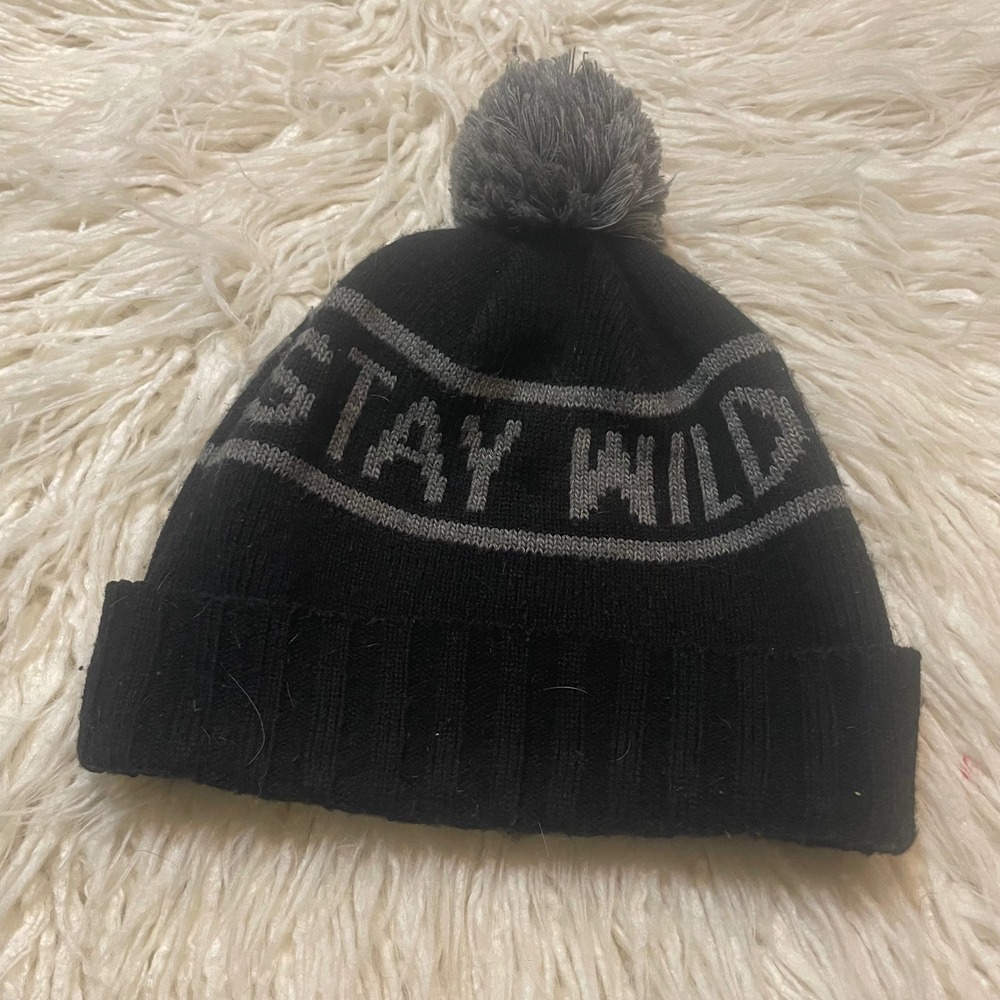 Black Knit Beanie Hat With Gray Stay Wild Text‎ Pom Pom
